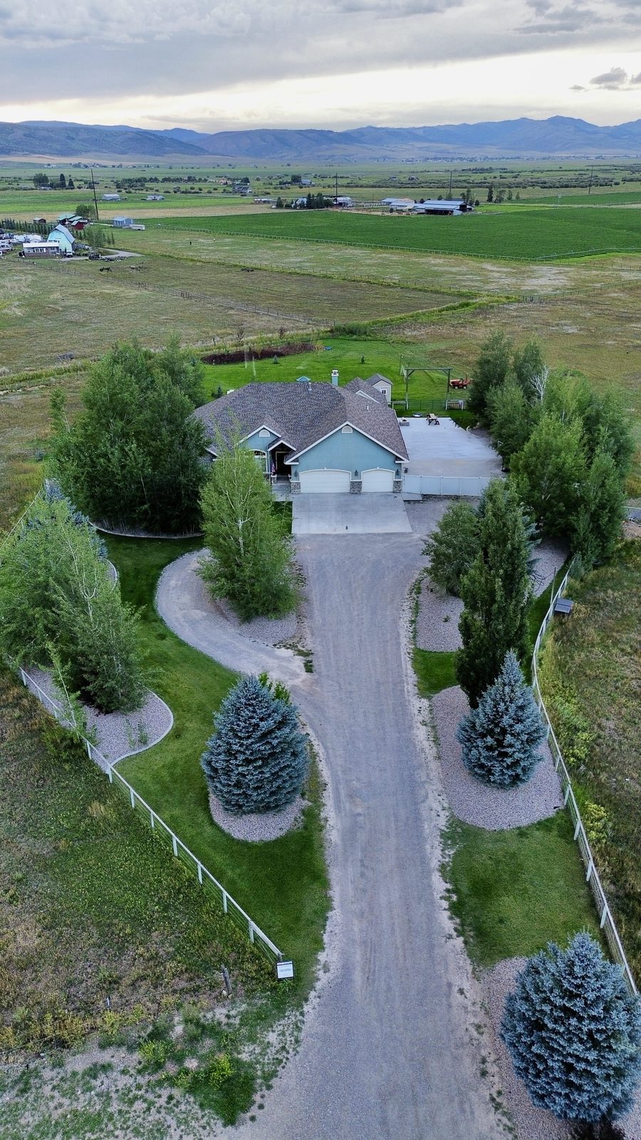 Aerial drone photo of a Star Valley Wyoming home and acreage with mountains behind