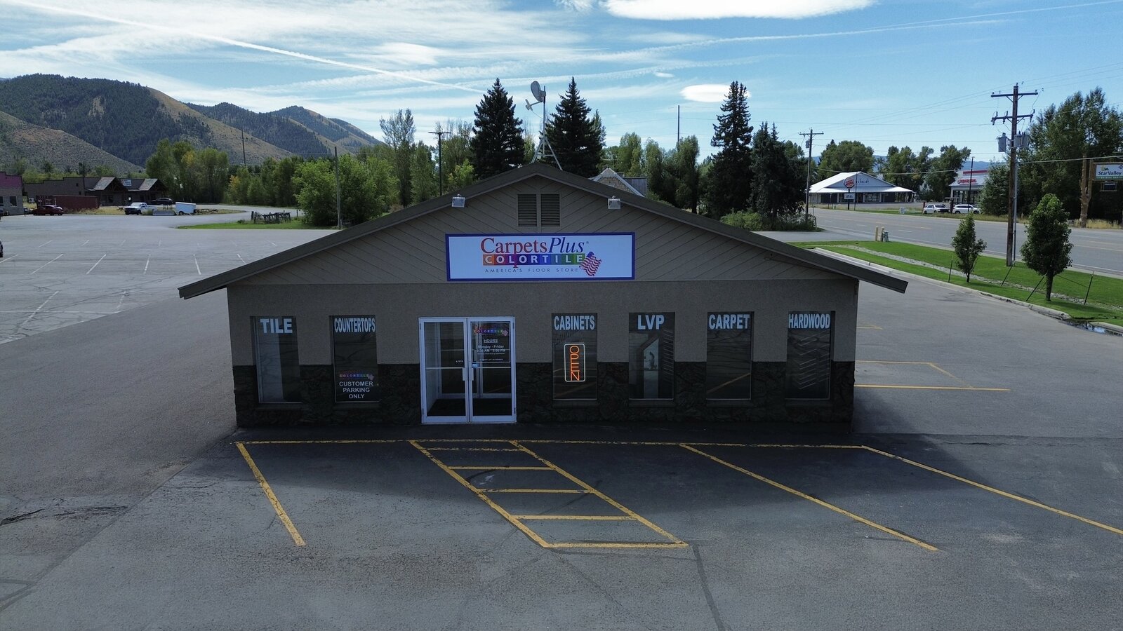 Aerial drone photo of a Carpets Plus ColorTile flooring storefront and parking lot